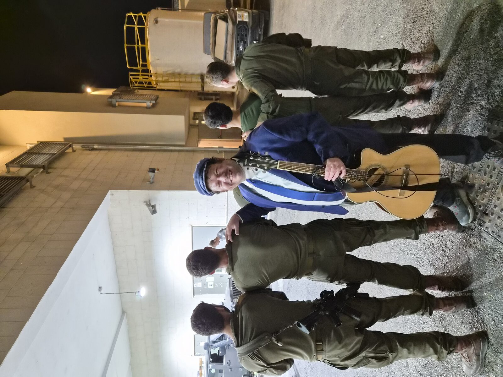 With soldiers at night, on base in Israel