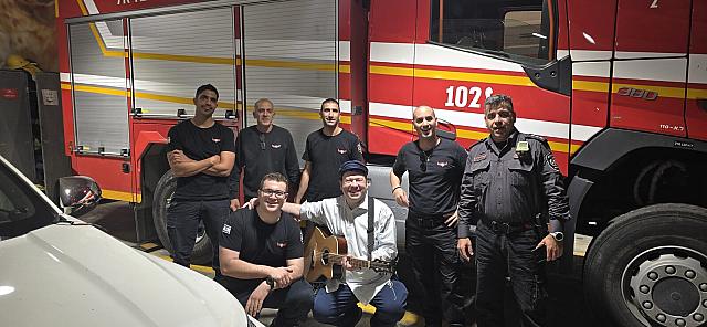 With Israeli firefighters in front of a fire truck