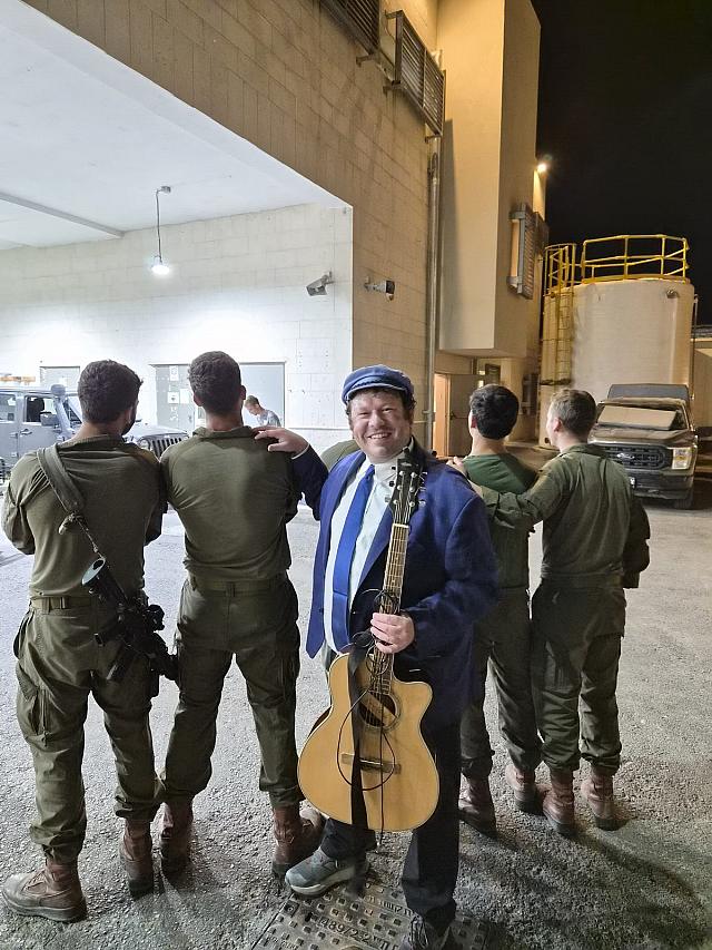 With soldiers at night, on base in Israel